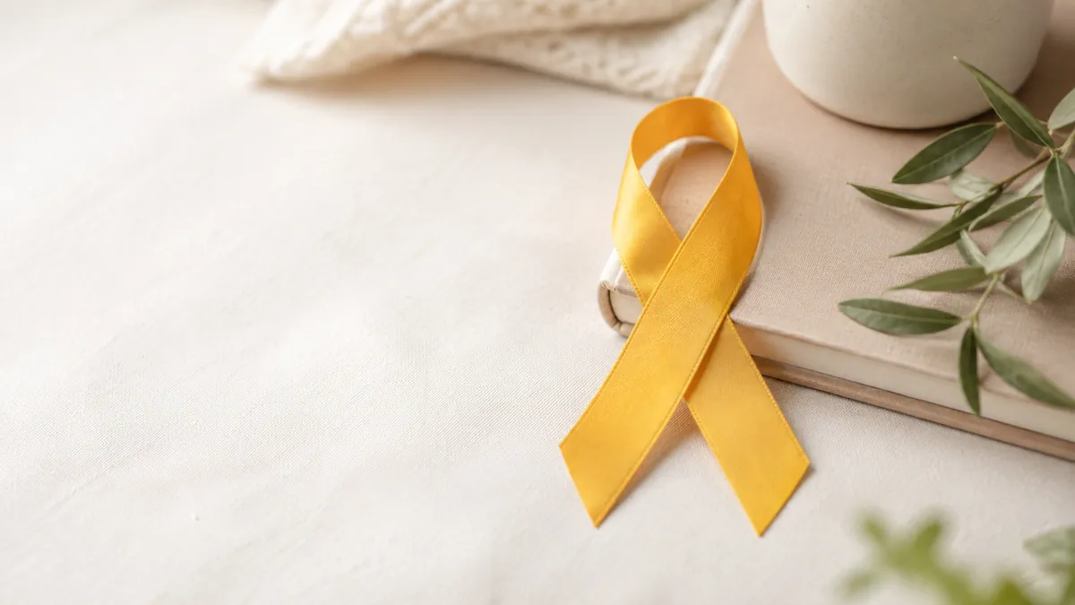 Laço amarelo sobre superfície clara, representando a campanha Setembro Amarelo e a prevenção do suicídio